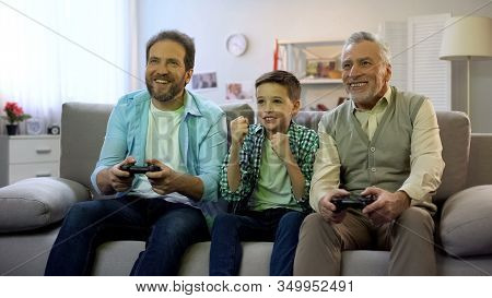 Preteen Boy Cheering For Dad And Granddad Playing Video Game, Pappy Time, Hobby
