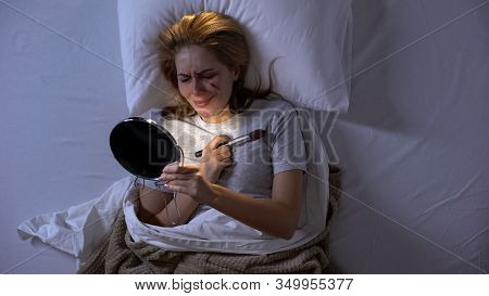 Crying Lady With Wound On Face Looking In Mirror Lying In Bed, Domestic Violence