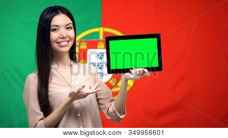 Girl Holding Tablet With Green Screen, Portuguese Flag On Background, Migration