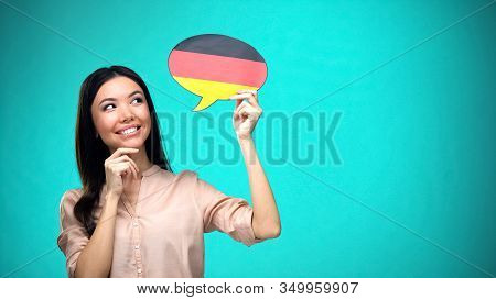 Curious Woman Holding German Flag Sign, Learning Language, Education Abroad