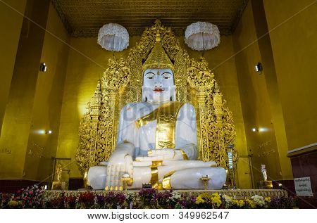 Mandalay, Myanmar - January 8, 2019: Large White Marble Buddha Statue in Kyauktawgyi Pagoda