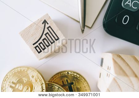 Graph Rising Up Growht Exponencial Sign On Wooden Cube With Objects Such As Gold Coin, Calculator An