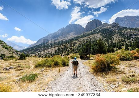 Turkey, Chamard - August 3, 2019: Tourists Walk Along The Road Through The Mountain Landscape In The