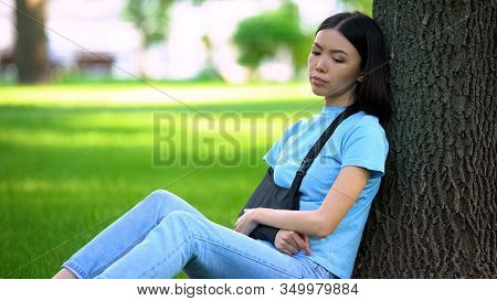 Sad Lady With Injured Arm In Supporting Sling Sitting Tree In Park, Medicine