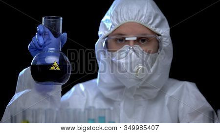 Worker Of Toxic Lab Examining Flask With Biohazard Liquid, Runoff Water Analysis