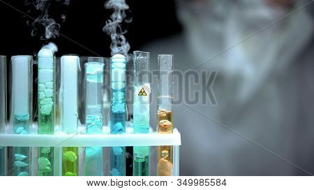 Test Tubes With Dangerous Liquid Boiling, Ionic Radiation Symbol, Research