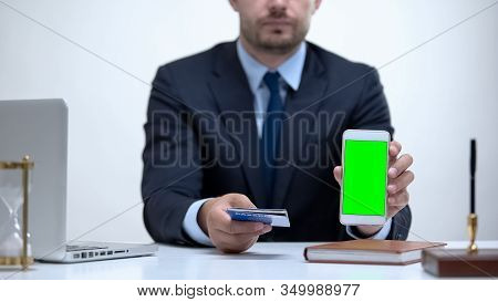 Consular Officer Holds Passport And Cellphone, Online Queue For Visa Application