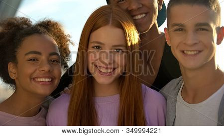 Joyful Teenagers Hugging Female Friend Smiling On Camera, Adolescent Wellness