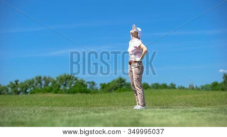 Inexperienced Woman Golfer Dissatisfied About Failed Shot, Looking Up, Loser