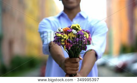 Mixed-race Boy Showing Colored Bouquet Of Flowers Into Camera, Delivery, Closeup