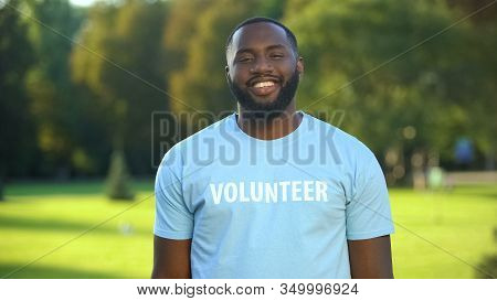 Cheerful Black Male Eco-volunteer Smiling To Camera, Nature Preservation Project