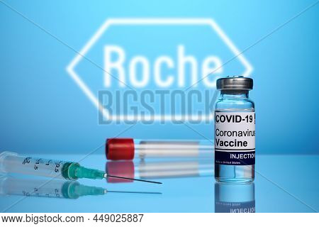 Krasnoyarsk, Russia - April 29, 2021: Roche Covid Vaccine And Syringe - Photo On A Blue Gradient Bac