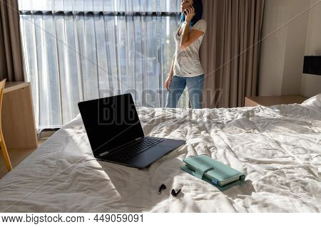 Woman With Blue Hair In Bedroom Work With Smartphone And Laptop