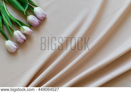 Spring Bouquet Of Pink Tulips On Beige Fabric With Folds