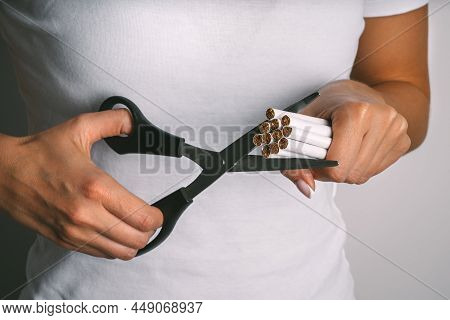 Woman Cutting Cigarettes With Scissors . Stop Smoking, Quit Smoking Or No Smoking. Woman Refusing To