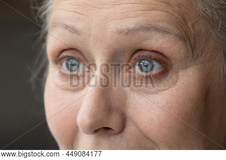 Blue Eyes Of Thoughtful Senior 70 Woman Looking Away