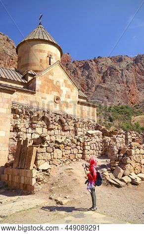 Female Visitor Taking Photos Of The Surb Karapet Or St. John The Baptist Church In Noravank Monaster