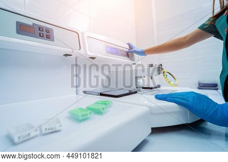 Laboratory Assistant Works At Paraffin Wax Dispenser Tissue Embedding Machine.