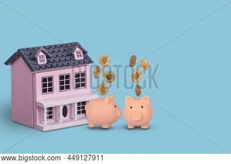 Couple In Love, Two Piggy Bank With Golden Bitcons And Wooden House On A Bright Blue Background. Cre