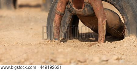 Mud Race Runners. The Participante Overcoming The Obstacle