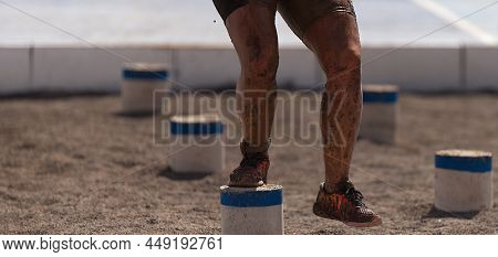 Mud Race Runners. The Participante Overcoming The Obstacle