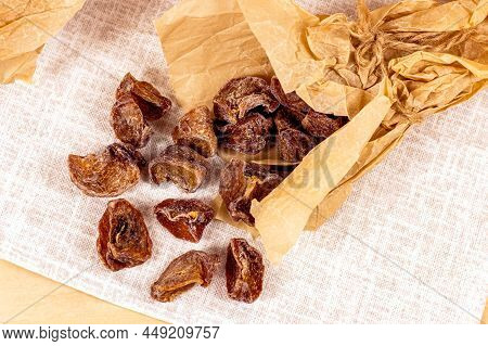 Traditional Japanese Hoshigaki Dried Persimmon Fruit Snack Slices In Wrapping Paper On Light Backgro