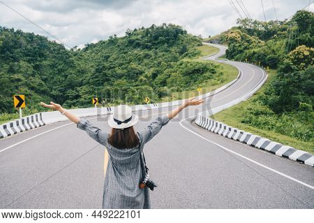 Asian Tourist Raised Her Hands While Looking To Beautiful Steep Curved Road (look Like Number 3) On 