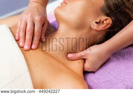 Facial Massage. A Woman Is Given A Massage In A Beauty Salon. Close-up.