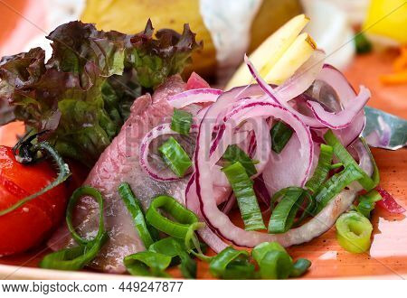 A Plate With Delicious Maties, Onions, Lettuce Lemons And Potatoes.