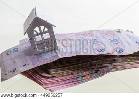 Uah Hryvnia Banknotes With Wooden House Isolated On White Background. Ukrainian Money. Concept Of Mo