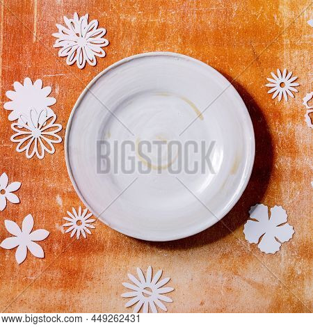 Empty White Plate With Paper Flowers Around
