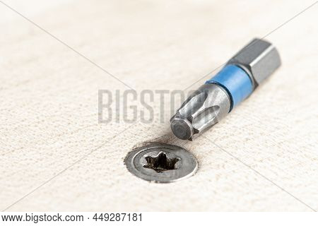 Screw The Screw Into The Board. Furniture Production, A Screwdriver Twists A Self-tapping Screw Into