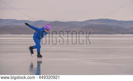 The Child Train On Ice Professional Speed Skating. The Girl Skates In The Winter In Sportswear, Spor