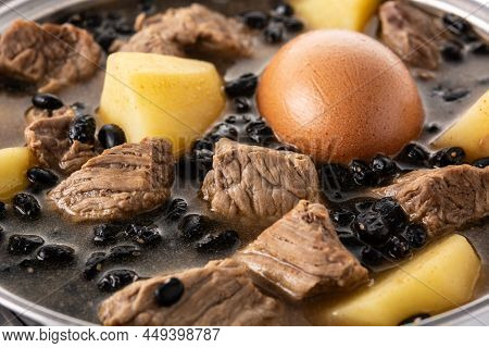 Traditional Jewish Cholent On Wooden Table. Close Up