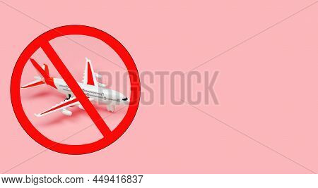 Top View Of A Toy Plane With A Prohibition Sign On A Pink Background. Overflight Ban