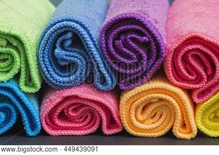 Colorful Rolled Up Microfibre Cleaning Cloths Arranged In A Rows.