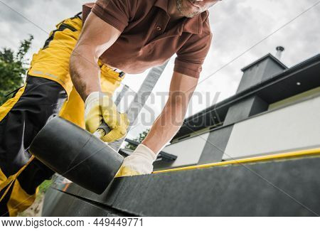 Professional Contractor Building Concrete Bricks And Tiles Backyard Patio. Using Soft Hammer To Adju