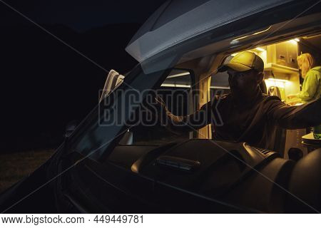 Caucasian Men In His 40s Closing Retractable Windshield Motorhome Camper Van Sun Shade For The Night