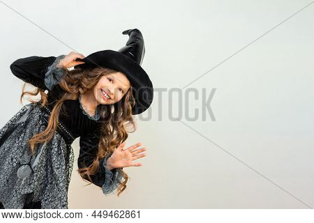 Dancing Enchantress With A Smile On Her Face. A Wizard On A White Background. A Little Girl In A Mag