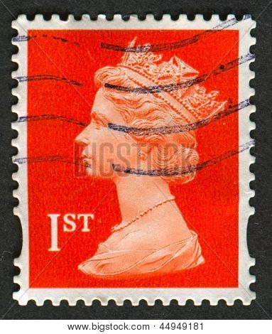 UK-CIRCA 1990:A stamp printed in UK shows image of Elizabeth II is the constitutional monarch of 16 sovereign states known as the Commonwealth realms, in red, circa 1990.