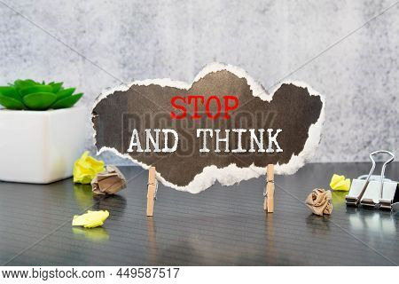 Text Stop And Think On White Paper.