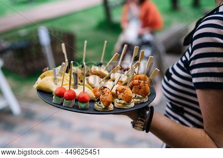 Waitress In Holding A Plate With Canapes. Catering Service. Wedding Welcome Food.
Сanapes (shrimp, M