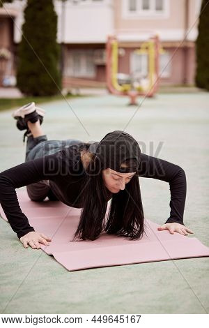 Young Slim Woman Doing Push Up Exercise Outside. Outdoor Workouts. Healthy Lifestyle Concept. Breath