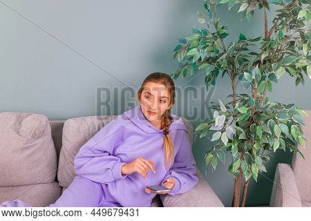 Happy Smiling Teenage Girl With Her Smartphone Browsing Social Newtwork, Communicating Relaxed On A