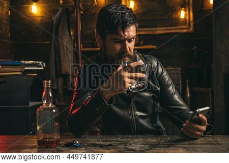 Man Is Chatting On Phone And Upset Alone At Home. Retro Vintage Man With Whiskey Or Scotch.
