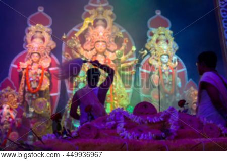 Blurred Image Of Goddess Durga Is Being Worshipped By Hindu Priest With Chamor. Vog, The Holy Food I