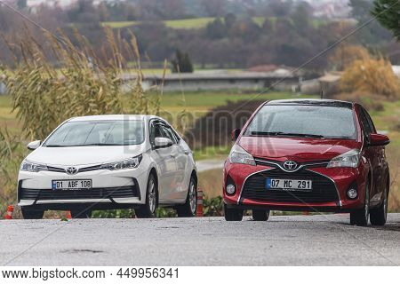 Side, Turkey -february  02, 2022: White  Toyota Corolla And Red Toyota Yaris  Is Parked  On The Stre