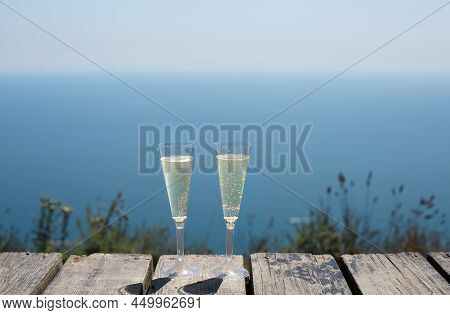 Champagne Glasses By The Blue Sea With Copy Space