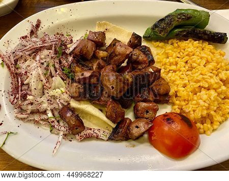 Turkish Liver Ciger With Bulghur Or Bulgur Rice. Served At Kebab Restaurant.
