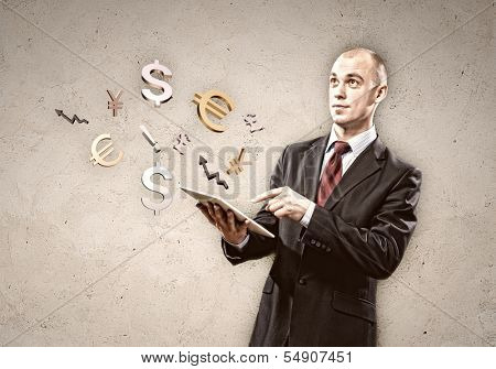 Image of businessman holding tablet pc. Finance concept